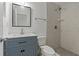 This bathroom features a modern vanity and walk-in shower with marble-like tile at 4638 Heavens Way, New Port Richey, FL 34652