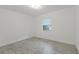 Bright bedroom with neutral-toned tiled floor and a window at 4638 Heavens Way, New Port Richey, FL 34652