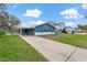 Charming single story home with teal and white paint, covered parking, and long driveway at 4638 Heavens Way, New Port Richey, FL 34652