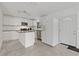 Bright kitchen with white cabinets, stainless steel appliances, and center island at 4638 Heavens Way, New Port Richey, FL 34652