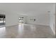 Spacious and well-lit living room with tile flooring and lake view through sliding glass doors at 4638 Heavens Way, New Port Richey, FL 34652