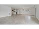 Open concept living area with tile floors and a view to the kitchen at 4638 Heavens Way, New Port Richey, FL 34652