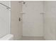 This walk-in shower is tiled with marble-like tile and has convenient shelves at 4638 Heavens Way, New Port Richey, FL 34652
