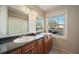 Bathroom with double sinks, granite countertops, and a large mirror at 4842 Coquina Key Se Dr # B, St Petersburg, FL 33705