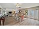 Bright dining room with wood floors, modern lighting, and views of the water at 4842 Coquina Key Se Dr # B, St Petersburg, FL 33705