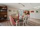 Dining room with view into the kitchen and living room featuring wood floors at 4842 Coquina Key Se Dr # B, St Petersburg, FL 33705