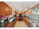 Well-lit kitchen featuring wood cabinets, granite countertops, and stainless steel appliances at 4842 Coquina Key Se Dr # B, St Petersburg, FL 33705