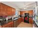 Well-lit kitchen featuring wood cabinets, stainless steel dishwasher, and a ceiling fan at 4842 Coquina Key Se Dr # B, St Petersburg, FL 33705