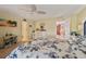 Bright main bedroom featuring a patterned bedspread, ceiling fan, and access to an attached bath at 4842 Coquina Key Se Dr # B, St Petersburg, FL 33705