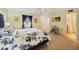 Bright main bedroom featuring a patterned bedspread, window with curtains, and closet at 4842 Coquina Key Se Dr # B, St Petersburg, FL 33705