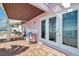 Outdoor patio showing water view, seating, and access to both the home and stairway at 4842 Coquina Key Se Dr # B, St Petersburg, FL 33705
