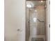 Walk in shower featuring handrails and tiled walls at 4842 Coquina Key Se Dr # B, St Petersburg, FL 33705