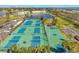 Aerial view of tennis courts in a lush landscape, perfect for sports enthusiasts and active living at 4842 Coquina Key Se Dr # B, St Petersburg, FL 33705