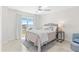 Comfortable bedroom featuring a queen bed, modern decor, water view through balcony doors at 4900 Brittany S Dr # 408, St Petersburg, FL 33715