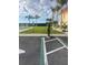 Exterior of community showing electric vehicle charging station, palm trees, and building architecture at 4900 Brittany S Dr # 408, St Petersburg, FL 33715