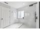 Modern bathroom featuring white marble tiles, walk-in shower, and sleek fixtures at 5323 Sandy Shell Dr, Apollo Beach, FL 33572