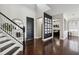 Bright foyer with hardwood floors, dark door and staircase, leading into other parts of the home at 5323 Sandy Shell Dr, Apollo Beach, FL 33572