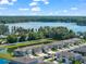 Aerial view of a community with waterfront properties, lush landscaping, and ample parking at 5994 Shiner St, Land O Lakes, FL 34638