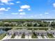 Aerial view of a community with waterfront properties, lush landscaping, and ample parking at 5994 Shiner St, Land O Lakes, FL 34638
