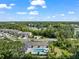 Aerial view of a community pool and lake homes, highlighting the surrounding nature at 5994 Shiner St, Land O Lakes, FL 34638