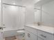Clean bathroom featuring tiled shower-tub, white vanity, and modern fixtures at 5994 Shiner St, Land O Lakes, FL 34638