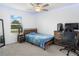 Bedroom featuring a bed with blue bedding, desk, computer chair, and LED lighting at 5994 Shiner St, Land O Lakes, FL 34638