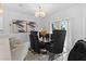 Elegant dining room with a chandelier, modern art, and stylish black chairs at 5994 Shiner St, Land O Lakes, FL 34638