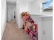 Upstairs hallway with toys and pink decor in the alcove, window, and neutral carpet at 5994 Shiner St, Land O Lakes, FL 34638