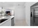 Modern kitchen seamlessly connects to the living area, featuring stainless steel appliances and sleek countertops at 5994 Shiner St, Land O Lakes, FL 34638