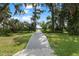 Picturesque wooden pathway leading through lush greenery to a serene waterfront view at 5994 Shiner St, Land O Lakes, FL 34638