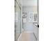 Bright bathroom with a glass enclosed shower, window with blinds, and white cabinets at 611 Brightwaters Ne Blvd, St Petersburg, FL 33704