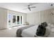 Bright main bedroom with white drapes and access to a private outdoor patio at 611 Brightwaters Ne Blvd, St Petersburg, FL 33704