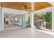 Inviting outdoor living space featuring a stainless steel grill, wood ceiling and seamless transition to the kitchen at 611 Brightwaters Ne Blvd, St Petersburg, FL 33704