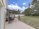 Backyard with a charming pergola, a patio and a lush green lawn, creating an outdoor space at 6512 N 24Th St, Tampa, FL 33610