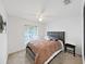 Comfortable bedroom with a ceiling fan and a plush bed with a tufted headboard at 6512 N 24Th St, Tampa, FL 33610
