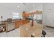 Modern kitchen with a granite island, stainless steel appliances, and wood cabinets at 6512 N 24Th St, Tampa, FL 33610