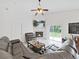 Bright living room featuring a fireplace, sliding doors, and a ceiling fan at 6512 N 24Th St, Tampa, FL 33610