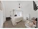 Bright main bedroom featuring canopy bed, ceiling fan, and makeup table at 6512 N 24Th St, Tampa, FL 33610