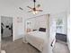 Tranquil main bedroom featuring canopy bed, ceiling fan, and en-suite bathroom at 6512 N 24Th St, Tampa, FL 33610