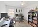 Functional home office setup featuring dual monitors, a rolling chair, and ample shelving at 6512 N 24Th St, Tampa, FL 33610