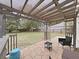 Relaxing covered patio with stone flooring and view of the spacious backyard, perfect for outdoor entertaining at 6512 N 24Th St, Tampa, FL 33610