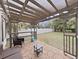 Outdoor patio featuring a pergola, stone flooring and stylish furniture for relaxation at 6512 N 24Th St, Tampa, FL 33610