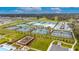 Community aerial view showcases extensive tennis and sports courts, a playground, and ample parking at 6927 Shelby Lynn Way, Zephyrhills, FL 33542