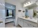 Bathroom featuring a double sink and bedroom view at 6927 Shelby Lynn Way, Zephyrhills, FL 33542