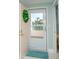 Light and airy entryway featuring a welcome mat and a glimpse of the lush, tropical scenery at 8041 Sailboat Key S Blvd # 101, St Pete Beach, FL 33707