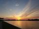 A view of the waterway with the setting sun reflecting bright yellow and gold colors on the water at 8041 Sailboat Key S Blvd # 101, St Pete Beach, FL 33707