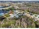 An elevated aerial view of the house, capturing its proximity to extensive woods, highways and lakes at 8233 Danubian Pl, Trinity, FL 34655