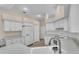 Well-lit kitchen with white cabinets, countertops, and appliances, offering a clean and modern design at 8233 Danubian Pl, Trinity, FL 34655