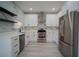 Bright kitchen featuring stainless steel appliances, white cabinets, and modern fixtures at 8901 N 20Th St, Tampa, FL 33604