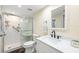 Bathroom with a white vanity, tile shower with glass door, black fixtures, and modern style at 9525 Blind Pass Rd # 301, St Pete Beach, FL 33706